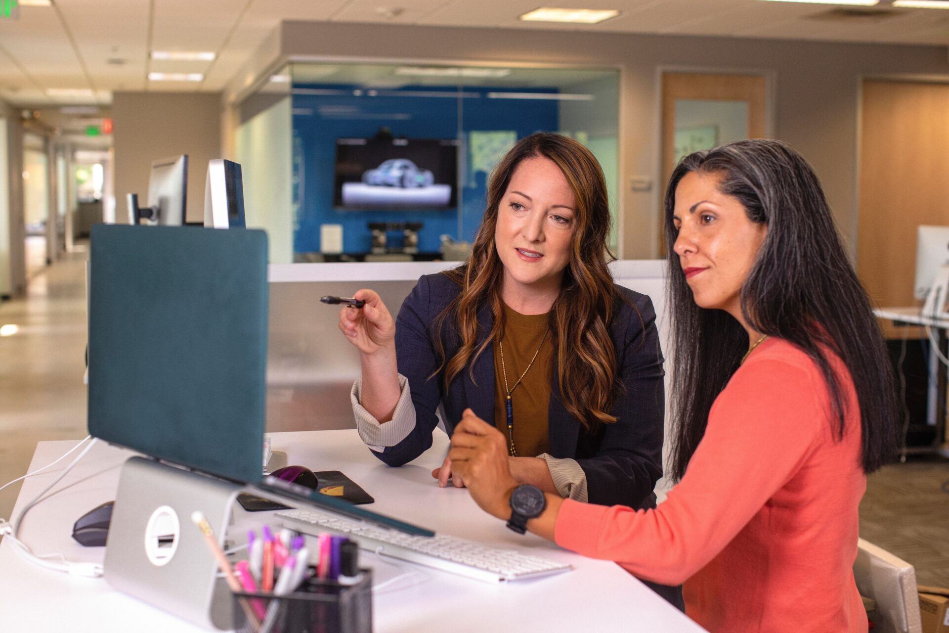 Two Women Sitting in Front of a Computer