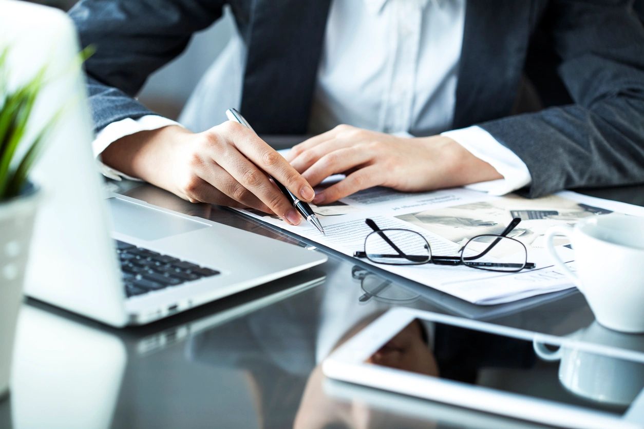 A Man Wearing a Suit Holding a Pen