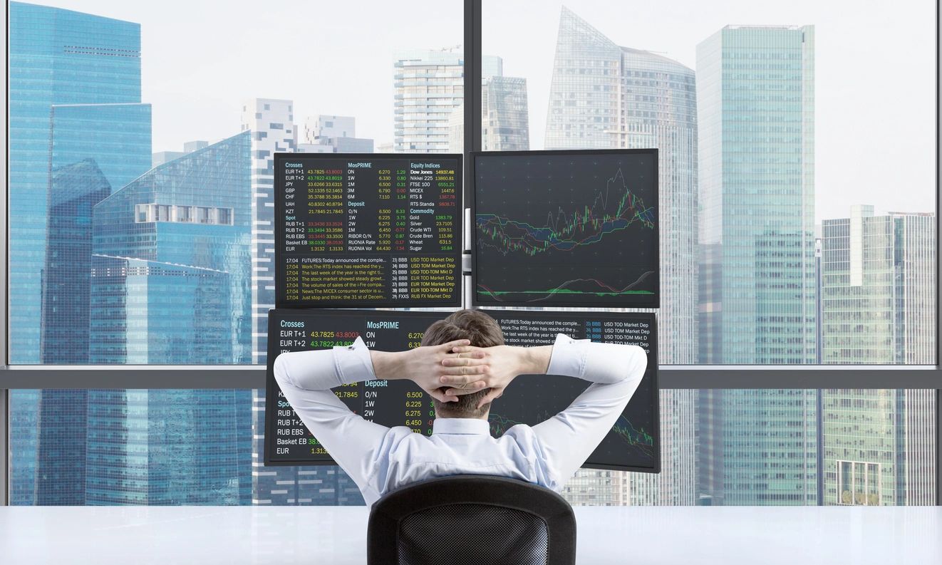 A Man Looking at Four LED Screens